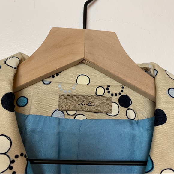 I.e. Tan trench coat with Mod circle design. - Picture 2 of 8